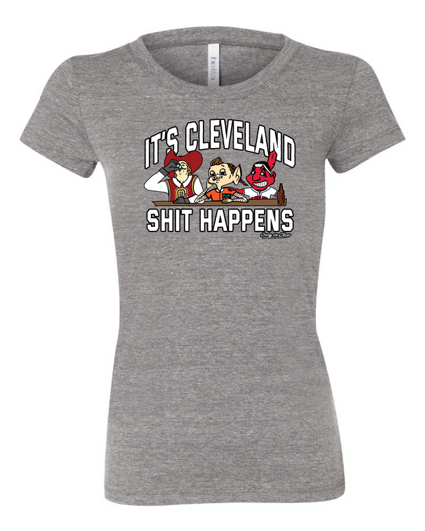 A grey women's  t-shirt with the text 'IT'S CLEVELAND SHIT HAPPENS' on the front, featuring cartoonish sports characters.